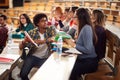 Young college students branstorming and comparing notes Royalty Free Stock Photo