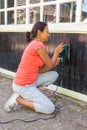 Young woman sheds wood of house Royalty Free Stock Photo