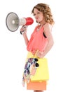 Young colorful dressed woman shopping and shouting trough loudspeaker Royalty Free Stock Photo