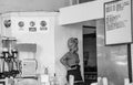 Young columbian woman dressed in traditional dress inside the restaurant where she is working as a waitress