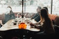 Young company is having fun and eating in bar. smoking a hookah, communicating in an oriental restaurant. Royalty Free Stock Photo