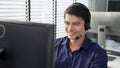 Young competent asian male call center agent working in the office. Royalty Free Stock Photo