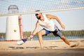 Young competetive man, athlete in singlasses playing paddle tennis, training outdoors on warm summer evening. Match