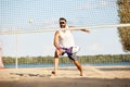 Young competetive man, athlete in singlasses playing paddle tennis, training outdoors on warm summer evening. Match