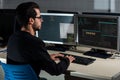 Young computer science student developing with his computer on a Linux System over double screen system Royalty Free Stock Photo