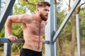 Young concentrated bearded strong man doing sports exercises