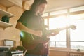 Young musician playing electric guitar at home Royalty Free Stock Photo