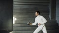 Young concentrated fencer man practice fencing exercises and training for Olympic games competition in studio indoors