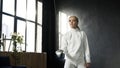 Young concentrated fencer woman training fencing exercise in studio indoors