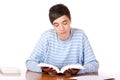 Young concentrated male student reading book Royalty Free Stock Photo