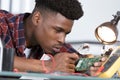 young concentrated man fixing electronics Royalty Free Stock Photo