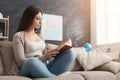 Young concentrated woman reading book