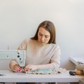 Concentrated seamstress sewing clothes at her own fashion atelier Royalty Free Stock Photo