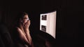 Young concentrated woman, sitting in her room or office .Studies late at night.Staying up late. Woman feeling headache Royalty Free Stock Photo