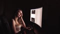 Young concentrated woman, sitting in her room or office .Studies late at night.Staying up late. Woman feeling headache Royalty Free Stock Photo