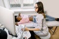 Young concentrated woman doctor conducts an ultrasound study of the abdomen of young African girl patient, and looking Royalty Free Stock Photo