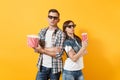 Young concerned couple woman man in 3d glasses watching movie film on date holding bucket of popcorn plastic cup of soda