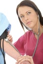 Young Concerned Professional Female Doctor Taking The Blood Pressure Of A Patient Royalty Free Stock Photo