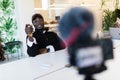 Young confident african man speaker talking on digital camera recording vlog. African male vlogger or business trainer speaking Royalty Free Stock Photo