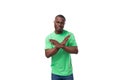 young confident american male advertiser dressed in green t-shirt with mockup gesturing