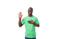 young confident american male advertiser dressed in green t-shirt with mockup gesturing