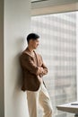 Young confident Asian business man executive looking at window thinking. Royalty Free Stock Photo