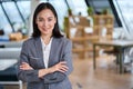 Young confident Asian business woman leader standing in office, portrait. Royalty Free Stock Photo