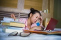 Young confident and beautiful Asian Korean student girl preparing University exam studying at home bedroom with laptop computer Royalty Free Stock Photo