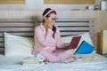 Young confident and beautiful Asian Korean student girl preparing University exam studying at home bedroom with laptop computer Royalty Free Stock Photo