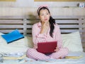 Young confident and beautiful Asian Korean student girl preparing University exam studying at home bedroom with laptop computer Royalty Free Stock Photo