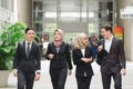 Young and confident business people walking together and having discussion each others Royalty Free Stock Photo