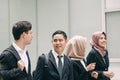 Young and confident business people walking together in a modern office corridor Royalty Free Stock Photo