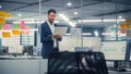 Young Confident Businessman Using Laptop Computer in Modern Office. Stylish Manager in a Suit Royalty Free Stock Photo