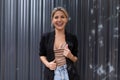 young confident businesswoman laughs against the background of embossed gray walls in the office Royalty Free Stock Photo