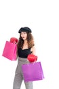 Young confident crazy asian woman wearing red boxing gloves and holding shopping bag isolated on white background. Shopping summer Royalty Free Stock Photo