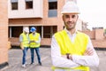 Young confident engineer architect standing at building construction Royalty Free Stock Photo