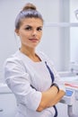 Young confident female dentist doctor with folded arms Royalty Free Stock Photo