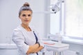 Young confident female dentist doctor with folded arms Royalty Free Stock Photo