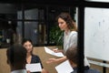 Female team leader giving out reports to focused colleagues. Royalty Free Stock Photo