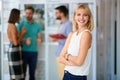 Young confident handsome blonde female watching at camera with her arms crossed in casual outfit Royalty Free Stock Photo