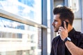 Bearded male leadership calling via cellphone during work in office Royalty Free Stock Photo