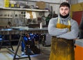 Blacksmith in metalworking workshop