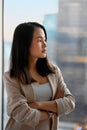 Young confident proud Asian business woman executive looking at window. Royalty Free Stock Photo