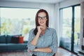 Young confident smart woman posing in living room