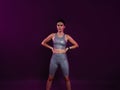 Young confident sportswoman in silver fitness attire