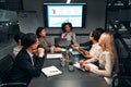 Young confident successful business people discuss and analyze work, statistics, plans, startup in a meeting room. Teamwork. Royalty Free Stock Photo