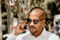 Young confident urban professional man using smart phone. African american male businessman using mobile smartphone for Royalty Free Stock Photo