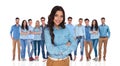 Young confident woman standing in front of her casual group Royalty Free Stock Photo