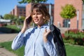 Young confused businesswoman in park calling by phone