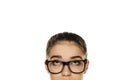 Young confused woman with glasses looking up